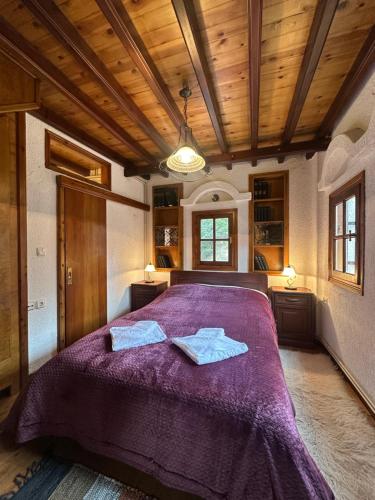 a bedroom with a purple bed with two towels on it at Arctic Loft by Ski Alure in Arachova