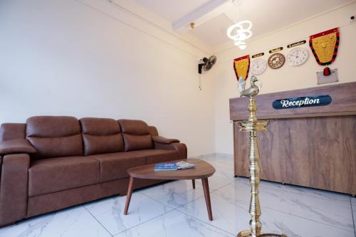 a living room with a couch and a table at Hotel Diamond Castle in Manjeri