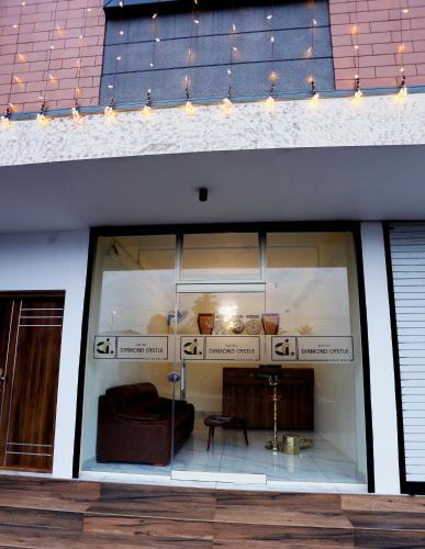 a window of a store with a couch in it at Hotel Diamond Castle in Manjeri