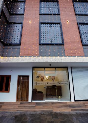 two different views of a building with a window at Hotel Diamond Castle in Manjeri