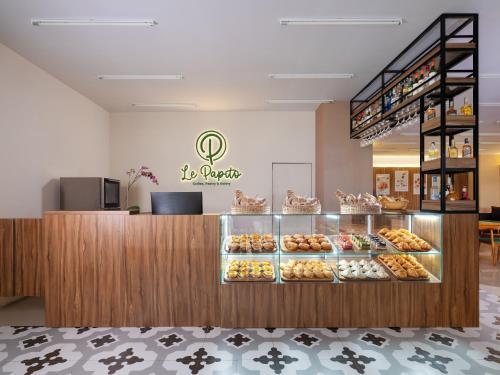 a bakery with a display case filled with pastries at The Alana Yogyakarta Hotel and Convention Center in Yogyakarta