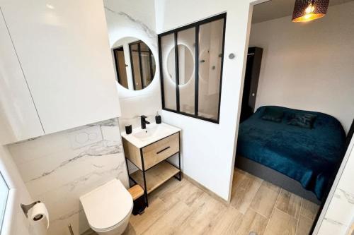 une petite salle de bain avec un lit et un lavabo dans l'établissement Lovely ! T2 neuf archi cosy 2, à Quimperlé