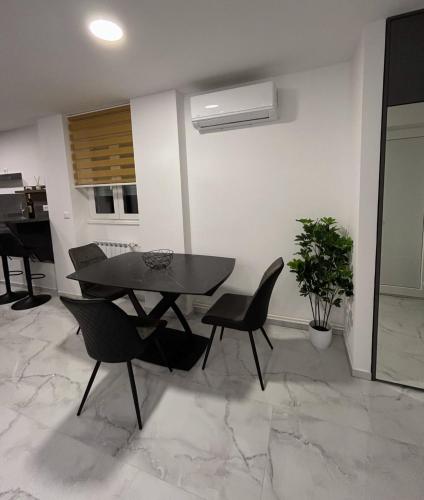 a dining room with a table and chairs and a piano at MA-LU apartment Osijek in Osijek