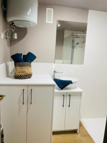 a white bathroom with a sink and a mirror at Apartamento Alba 2 in Jaca