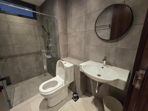 a bathroom with a toilet and a sink at K Avenue Kota Kinabalu by Merveille - Sabah in Donggongon