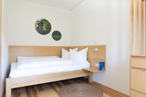 a bedroom with a bed and a table at Forsthaus Apartments - Die Ruheoase nahe Klaffer in Klaffer am Hochficht