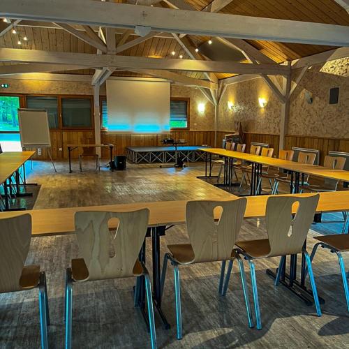 a large conference room with tables and chairs at Le Bois Dormant-Hôtel Restaurant & Spa Logis Hôtel in Champagnole