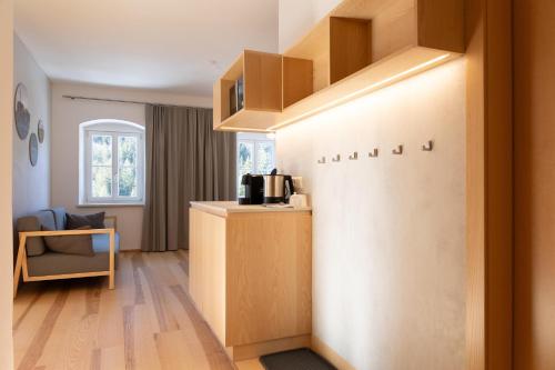 a room with a kitchen with a counter and a shelf at Forsthaus Apartments - Die Ruheoase nahe Klaffer in Klaffer am Hochficht