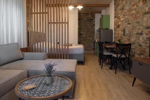 a living room with a couch and a table at The Lake House Angeliki in Kanália