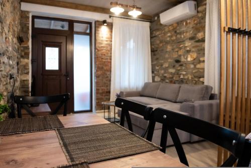 a living room with a couch and a table at The Lake House Angeliki in Kanália