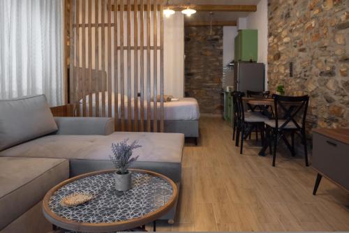 a living room with a couch and a table at The Lake House Angeliki in Kanália