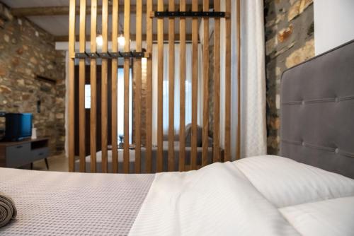 a bedroom with a white bed and a gate at The Lake House Angeliki in Kanália