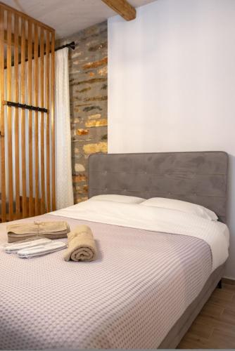 a bedroom with a bed with a wooden headboard at The Lake House Angeliki in Kanália