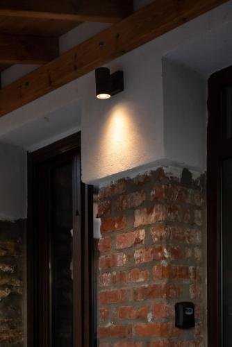 a light on top of a brick wall at The Lake House Angeliki in Kanália