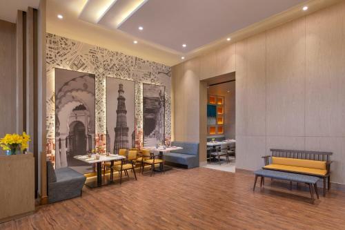 a restaurant with tables and chairs in a room at Welcomhotel by ITC Hotels, Delhi-Gurugram Highway in New Delhi