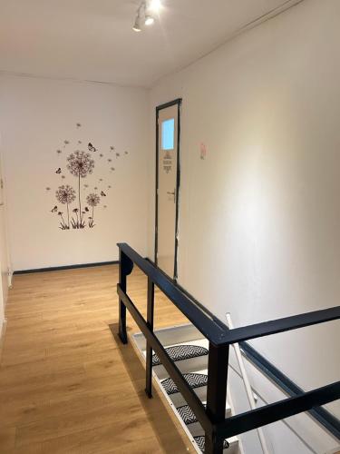 a room with a staircase and a wall with flowers on it at Stay and Sleep in Leeuwarden