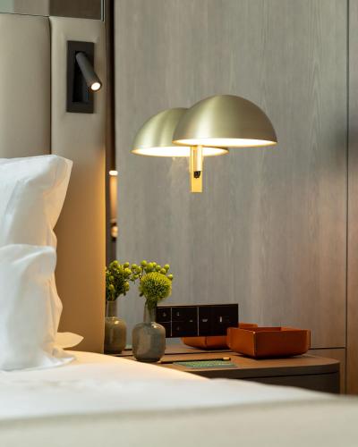 a bedroom with a bed and a lamp on a table at Altis Porto Hotel in Porto