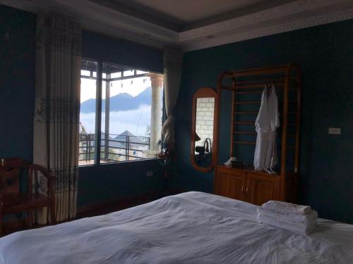 a bedroom with a bed and a large window at Sapa Family Homestay in Sa Pa