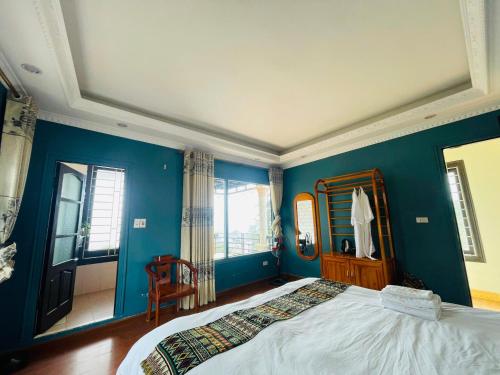 a bedroom with blue walls and a large bed at Sapa Family Homestay in Sa Pa