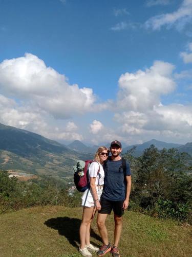 a man and woman standing on top of a hill at Sapa Family Homestay in Sa Pa
