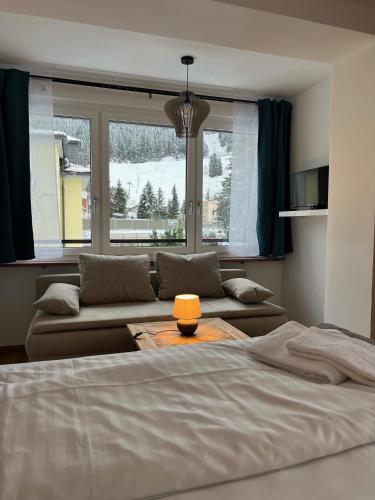 a living room with a bed and a couch at Stubnerkogel Apartments in Bad Gastein