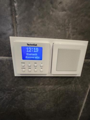 an electronic device with a clock on top of it at Haarle's kleine landhuis NR 3 in Haarle