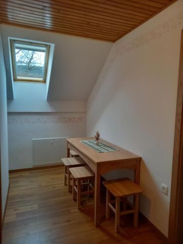 a table and chairs in a room with a window at Tourist Farm Arbajter in Resnik