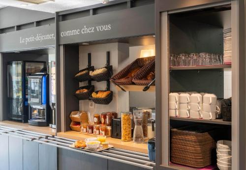 a bakery display case with bread and other food items at B&B HOTEL Amiens in Longueau
