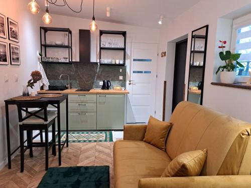 a living room with a couch and a table at Apartament Deluxe-Gontalowy in Kazimierz Dolny