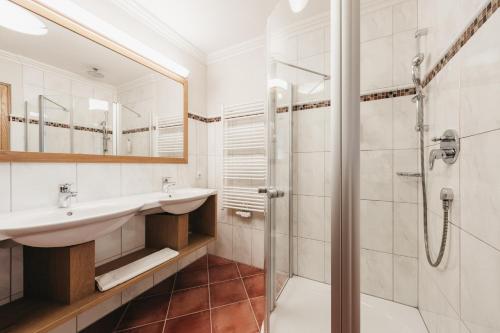a bathroom with a sink and a shower at Biohotel Rupertus in Leogang