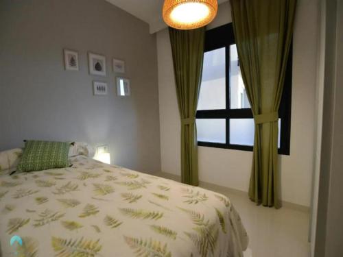 a bedroom with a bed and a window at Ground floor apartment in Pilar de la Horadada - Mil Palmeras Beach in Pilar de la Horadada