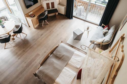 an overhead view of a living room with a bed and a table at Biohotel Rupertus in Leogang