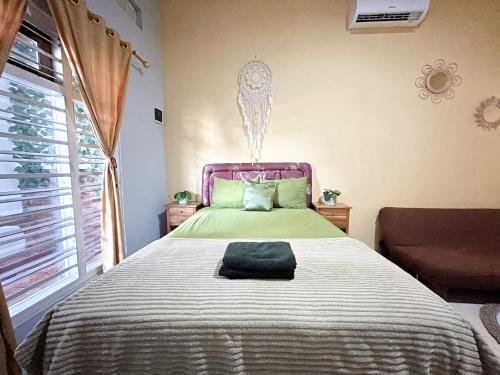 Ένα ή περισσότερα κρεβάτια σε δωμάτιο στο Rumah Boho