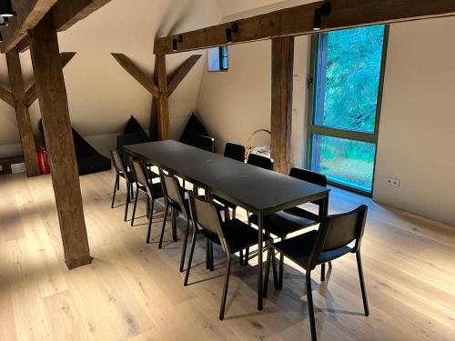 a black dining room table and chairs in a room at Peetri mõis & spa in Turva