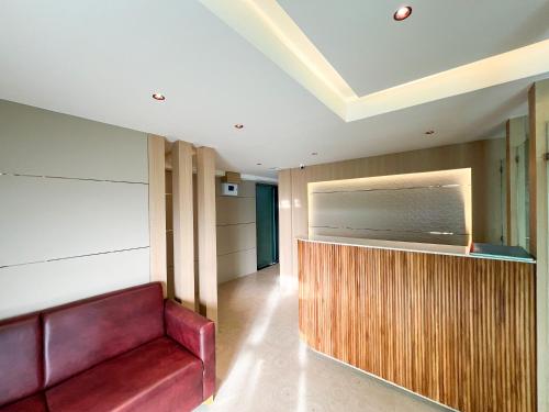 a living room with a couch and a television at Bandra Stays in Mumbai