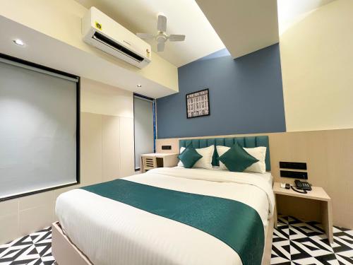 a bedroom with a large bed and a large window at Bandra Stays in Mumbai