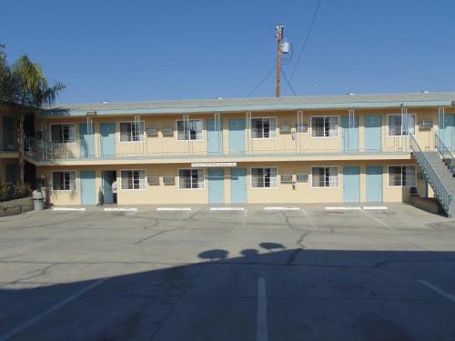 an empty parking lot in front of a building at Western Inn & Suites in Taft