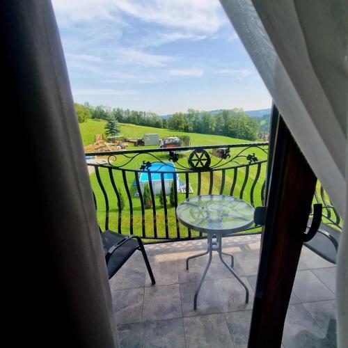 a view of a balcony with a table and chairs at Pokoje u Nasyj Kasi in Poronin