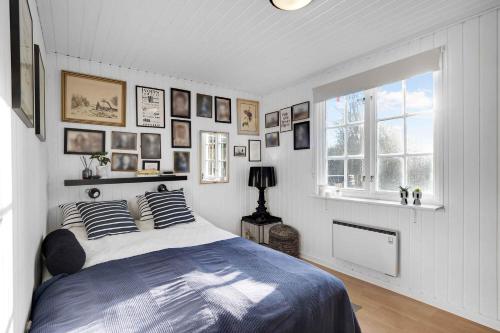 a bedroom with a bed with pillows and a window at Lovely House In Scenic Thy in Thyholm