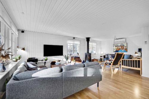 a living room with a couch and a tv at Lovely House In Scenic Thy in Thyholm