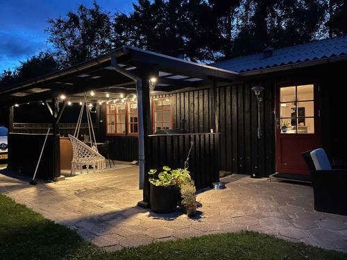 a patio with a pavilion with a swing at Lovely House In Scenic Thy in Thyholm