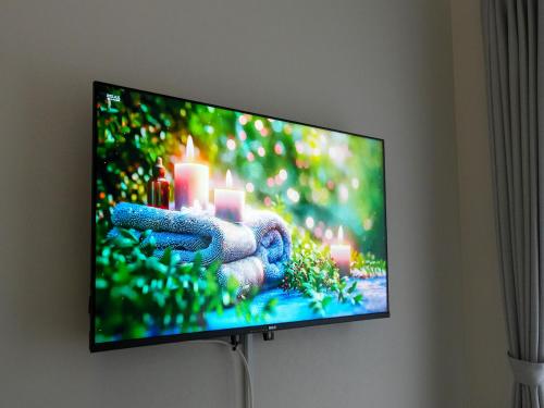 a flat screen tv hanging on a wall at OUCHI HOTEL Onaganishi in Hiroshima