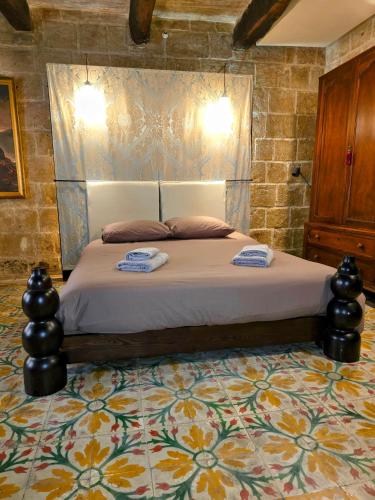 a bedroom with a bed with two towels on it at The Valletta G-House in Valletta