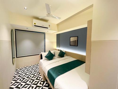 a hotel room with a bed and a projection screen at Bandra Stays in Mumbai
