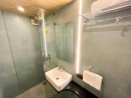 a bathroom with a sink and a mirror at Bandra Stays in Mumbai