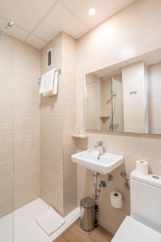 a bathroom with a sink and a shower at Hostal Pensimar in El Altet