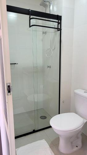 a bathroom with a glass shower with a toilet at Blend Coliving One - 2b in Ribeirão Preto