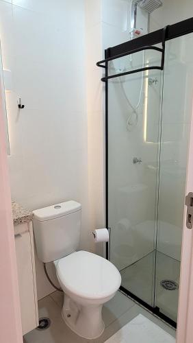 a bathroom with a toilet and a glass shower at Blend Coliving One - 2b in Ribeirão Preto