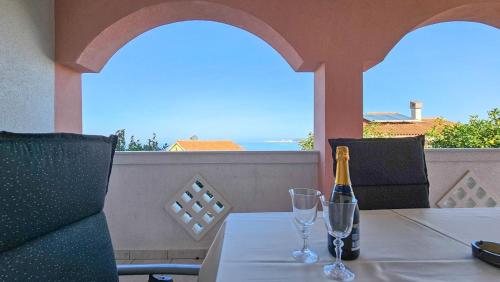 a bottle of champagne sitting on a table with two glasses at Stefi 1 in Crveni Vrh