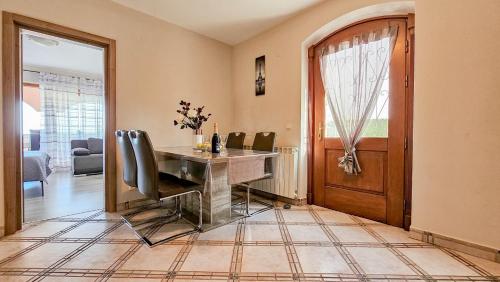 a dining room with a table and some chairs at Stefi 1 in Crveni Vrh